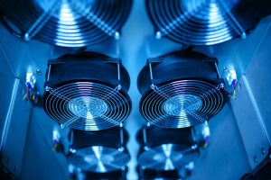 Close-up of cooling fans in a server room, showcasing technology and efficiency.